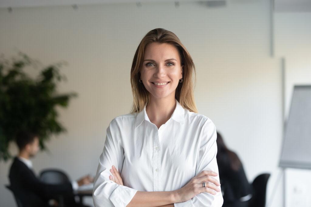 Smiling woman in office setting.