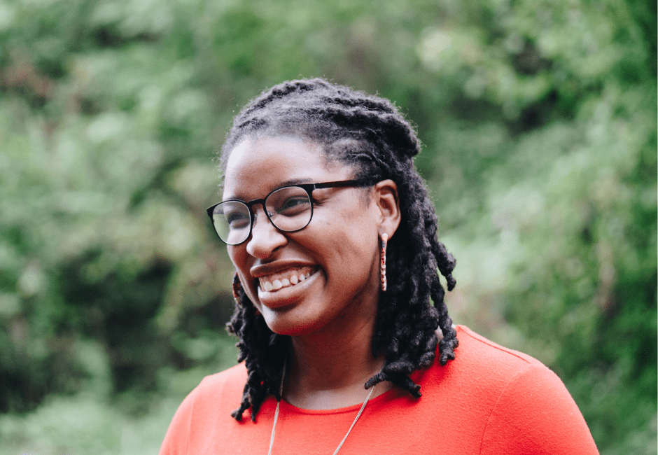 Smiling woman in red sweater.